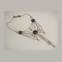 Peter Paul Pfeiffer (1879-1957) Germany, Festooned necklace with three large roundels of moss agate, eleven oval cabochons of opal, two round cabochons of opal and five round opal beads all bezel set in silver, c. 1900