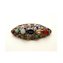 Sybil Dunlop (1889-1968) "Marquise" jewel set brooch, various precious and semiprecious jewels set in an openwork leaf design sterling brooch, c. 1920
