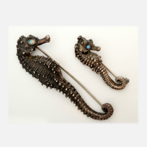 Carl Schon "Seahorse" Brooches, sterling set with fire opal eyes, signed, c. 1920's