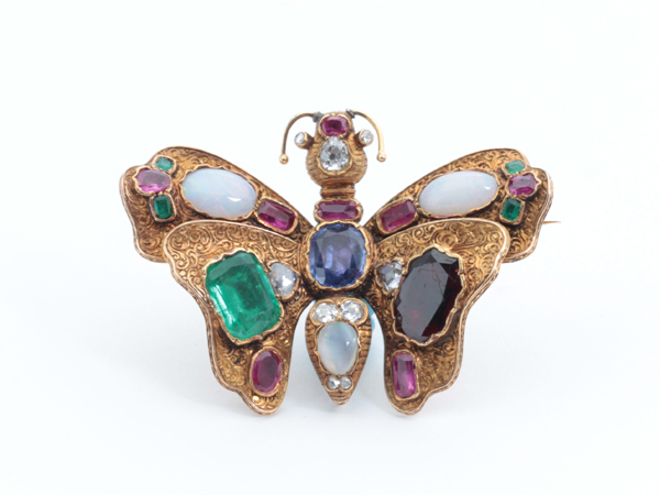 European gem set butterfly brooch with rubies, emeralds (3.5 carats TW), diamonds, opals, a sapphire (4 carats TW) and a garnet (5 carats TW) in 18K gold, c. 1880’s