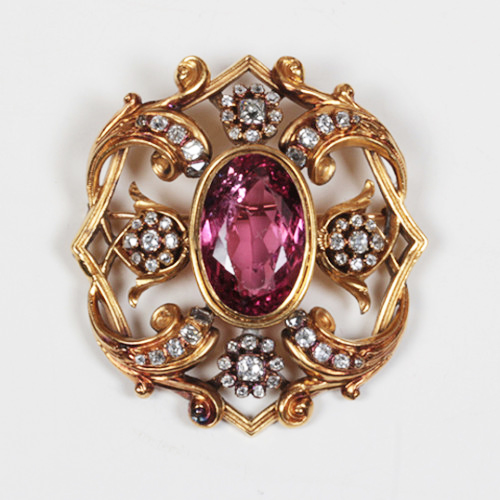 French 19th Century “Baroque” inspired brooch 18K yellow gold set with a large oval cut pink tourmaline (approx. 16 carats TW) and 59 rose cut diamonds (approx. 5 carats TW), marked, c. 1890
