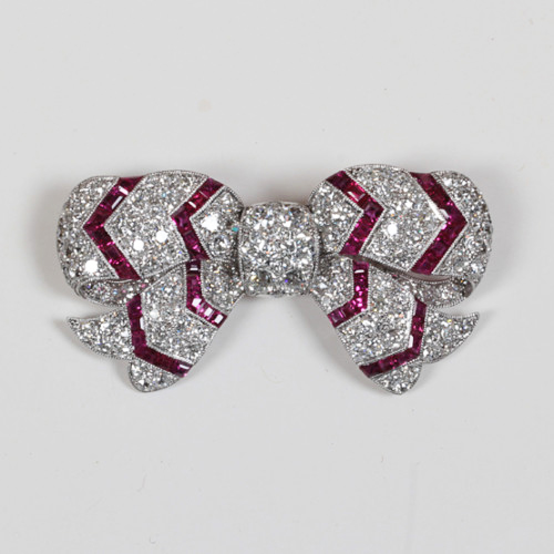 Art Deco “Bow” brooch, Diamonds (8 carats) and square cut rubies with a chevron motif, set in a dimensional platinum mount c. 1920’s