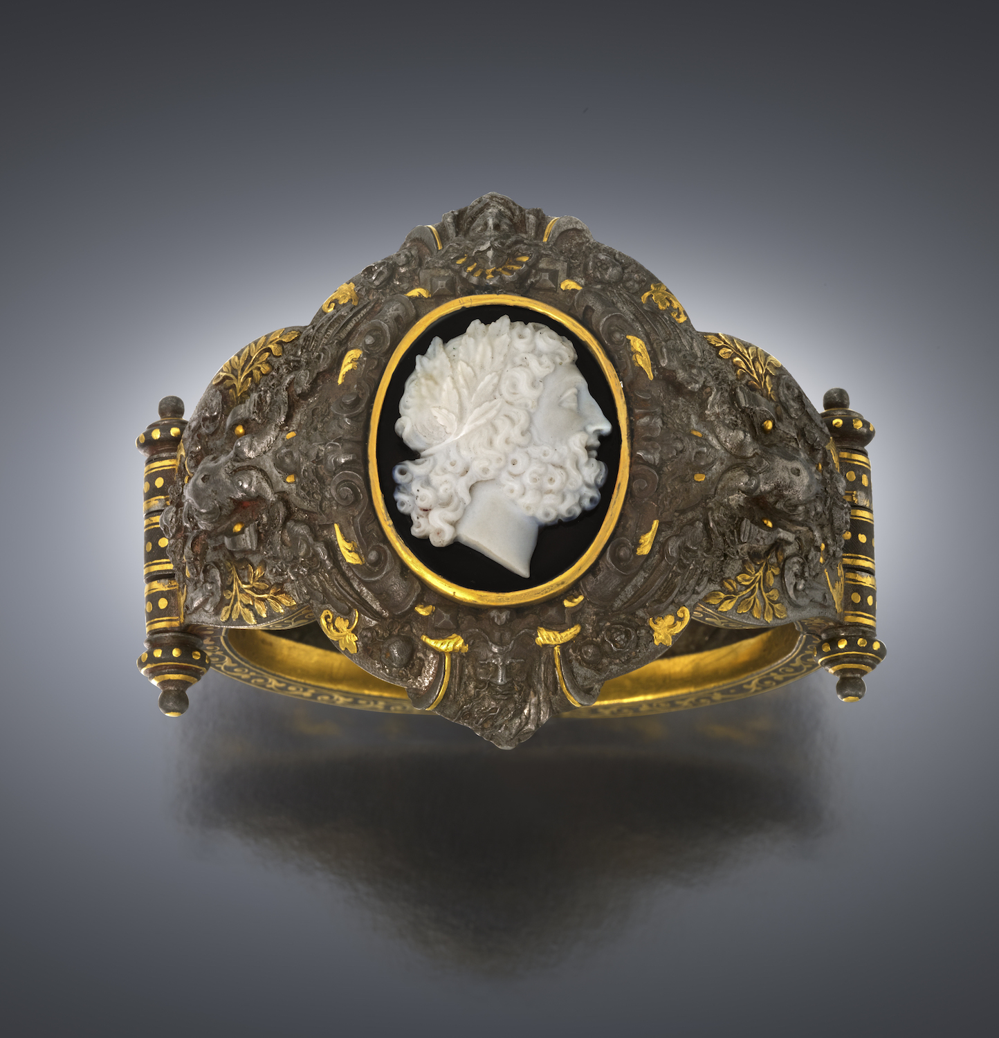 Boucheron “Renaissance Revival” cuff / bracelet, attributed to a design by Paul Legrand and made by Tissot, highly sculptural gold inlay, damascene steel set with an intricately agate carved cameo c. 1878