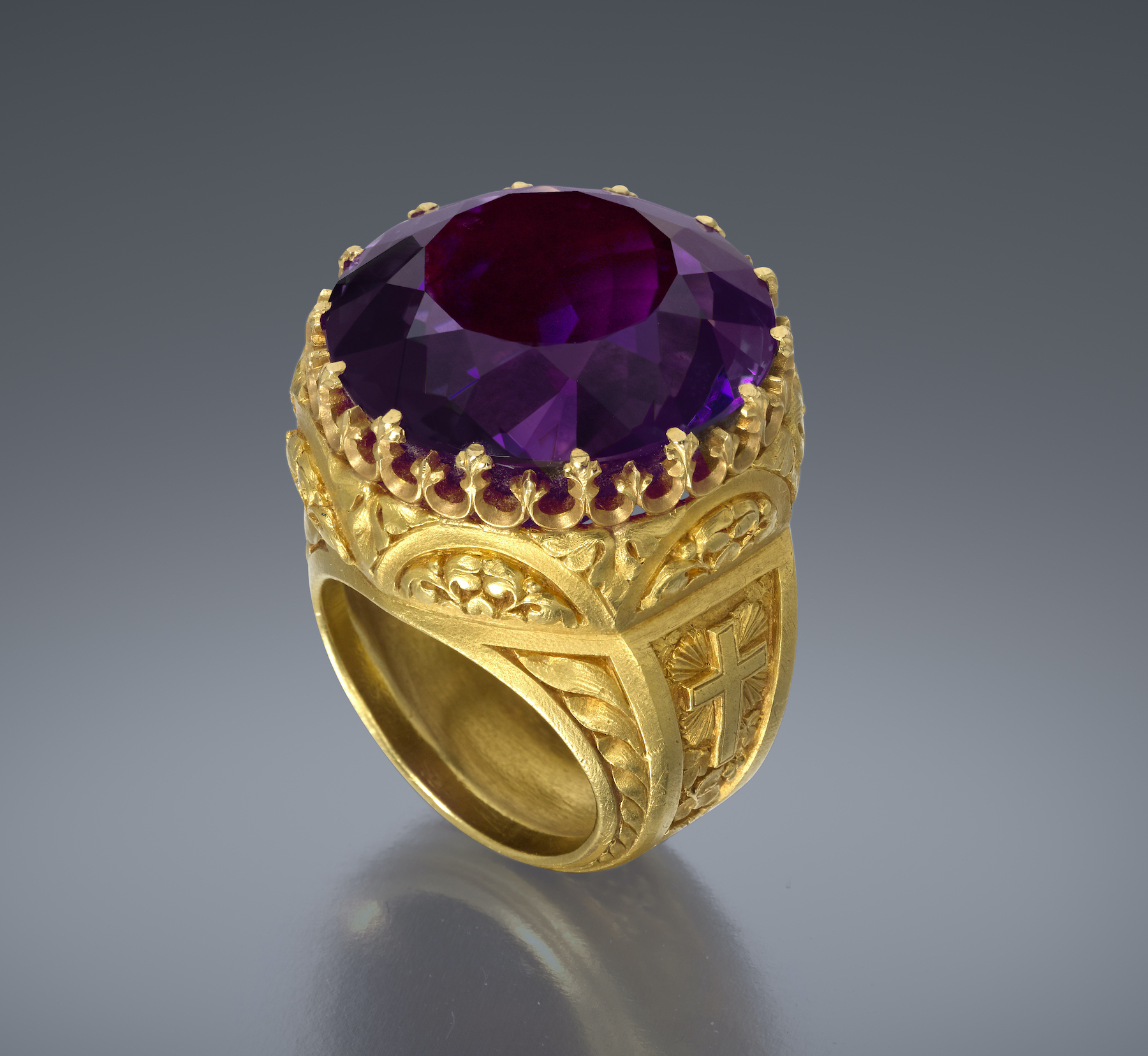 Dreicer & Co., New York, “Bishop’s” ring, elaborately detailed Gothic Revival 18K gold ring set with a large round cut “Siberian” amethyst (approx. 55 carats TW), original leather and silk velvet and satin lined box, c.1880
