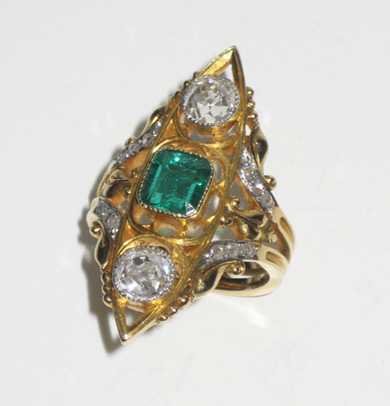 French 19th Century “Gothic Revival” ring set with a very fine square step cut emerald (approx. 2 carats TW) and two European rose cut diamonds (approx. 2 carats TW) all in an openwork 18K yellow gold mount further set with 12 old mine cut diamonds, signed, c.1885