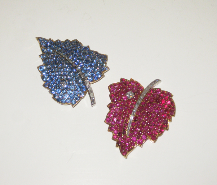 American Retro “Leaf” brooches, Burma sapphires (approx. 12+ carats), cabochon rubies (approx. 12+ carats) and baguette and round diamonds all set in 18K gold and platinum, marked, c. 1950