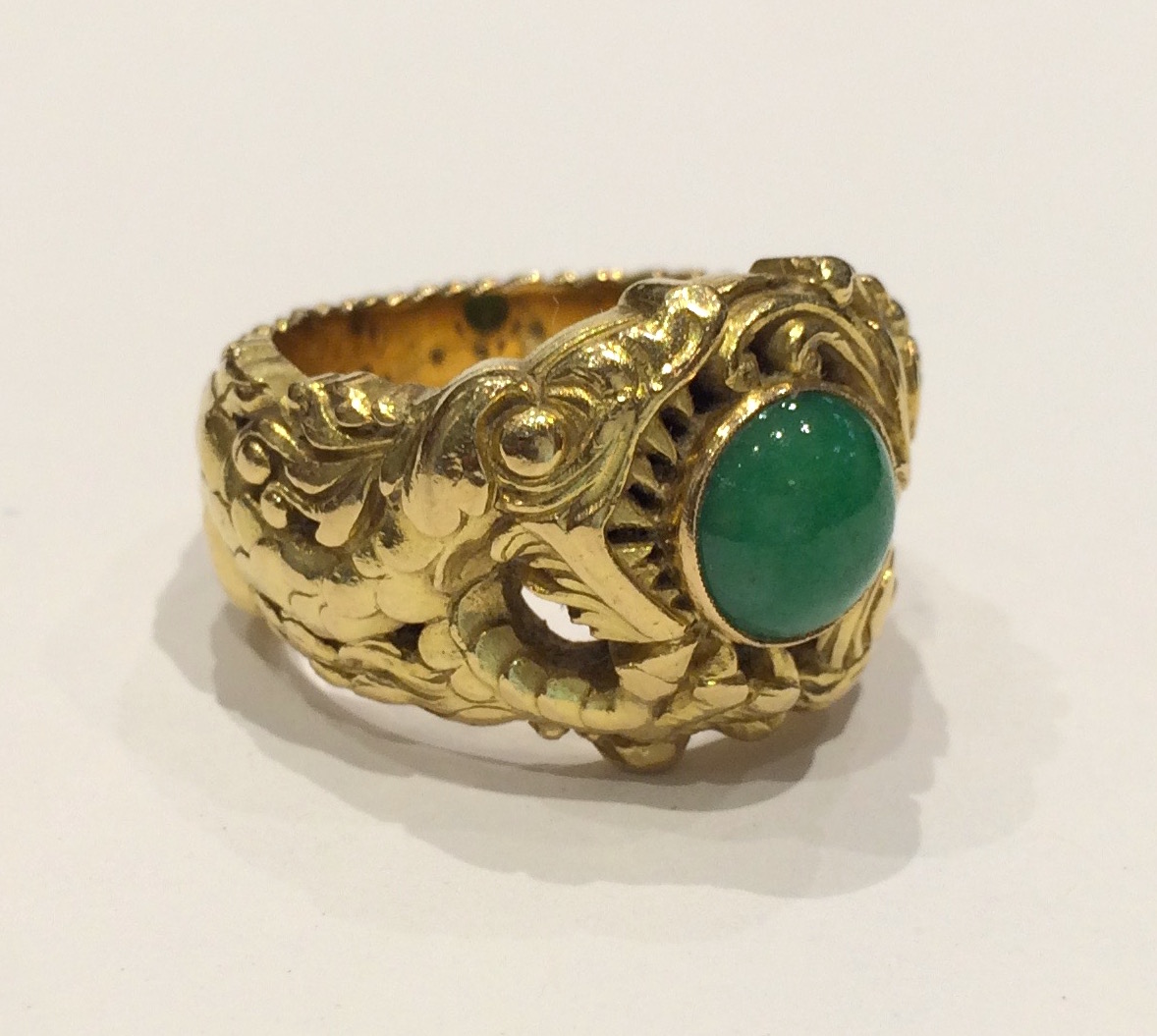 Rene Lalique (attr.) intricately carved and sculpted “Imperial Dragon” ring in 18k gold and set with a round jadeite jewel cabochon, signed, c. 1890