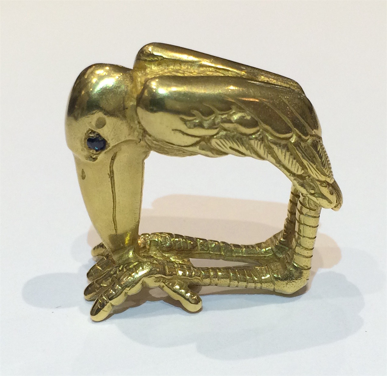 Moshe Oved (1883-1958) “Marabou Stork” ring, hand tooled lost wax 18K gold casting in full dimension as a complete biomorphic form of the bird and set with sapphire eyes,  c.1940