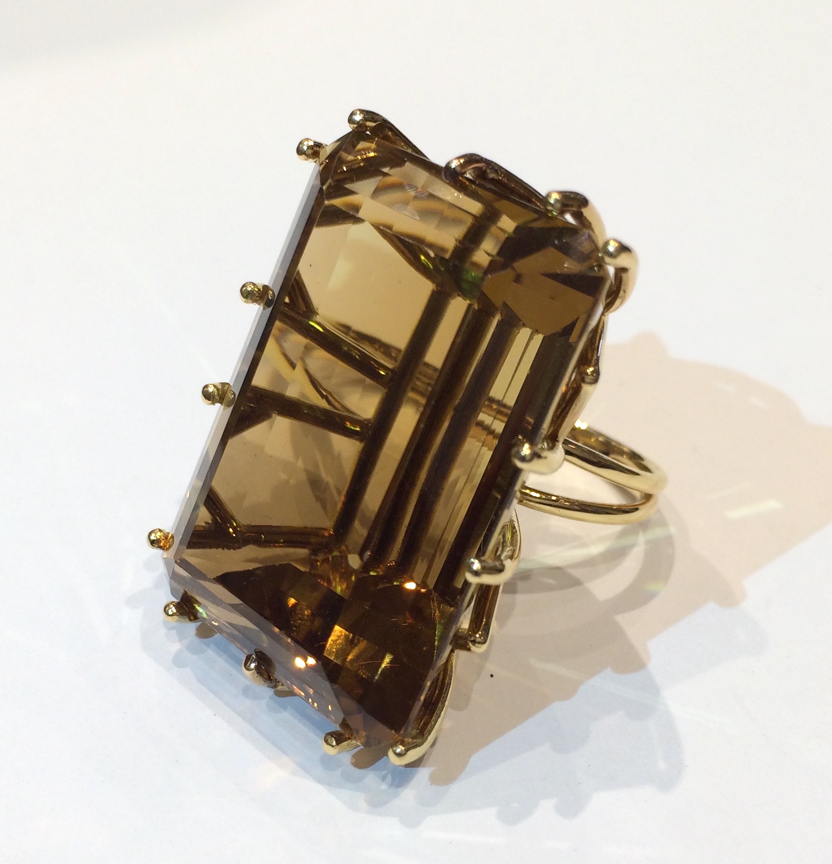 “Cognac” emerald cut large citrine (approx. 100 carats) ring set in an 18K yellow gold zigzag mounting,  c. 1940’s