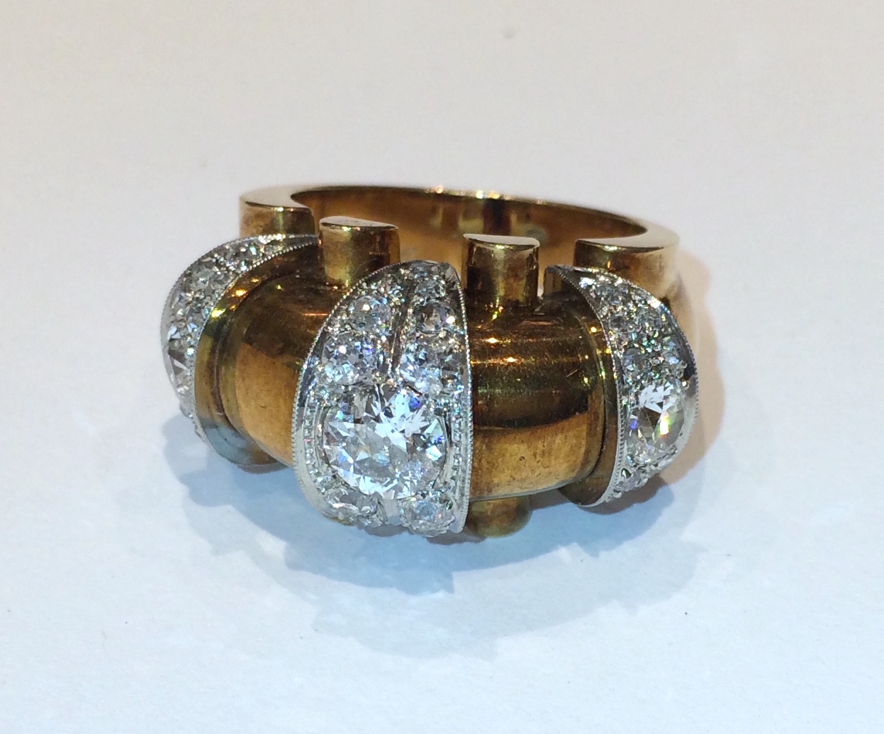 European Modernist ring set with three round diamonds (approx. 2 carats TW) and further set with 34 diamonds (approx. 4 carats TW) in three platinum sections on a 14K gold ring, signed, c.1930