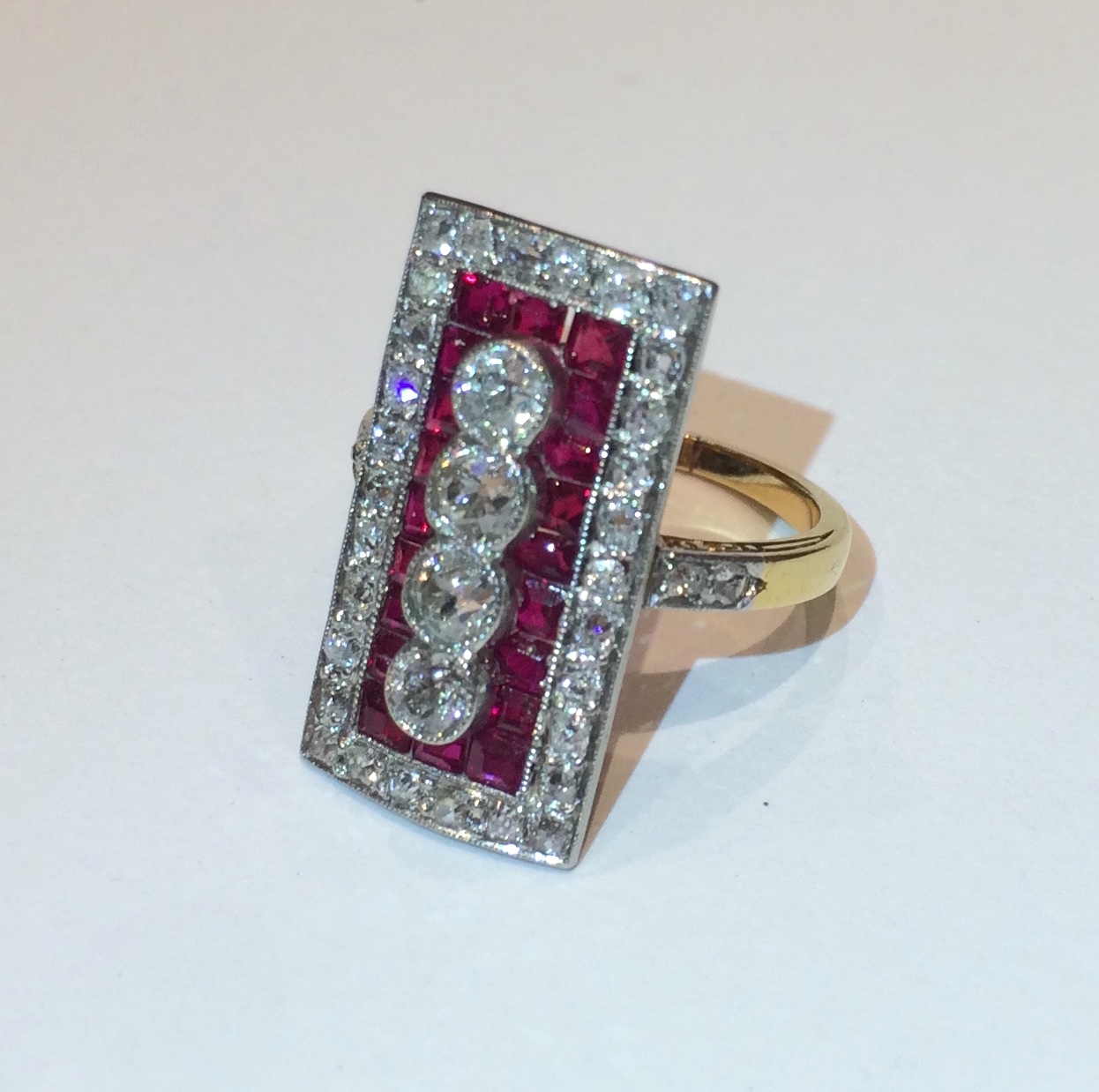Art Deco ruby and diamond ring set in platinum topped 18k yellow gold, four round diamonds (approx. 1 carat TW) set with 20 square and caliber cut natural rubies (approx. 3 carats TW) further set with 34 round diamonds (approx. 2.50 carats TW) c.1920