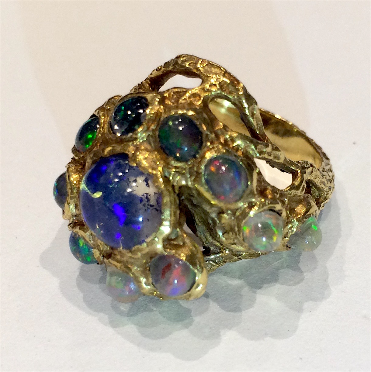 “Octopus” ring, 18K sculpted and highly textured gold set with 10 cabochon opals and a center fire opal, marked, c.1960’s