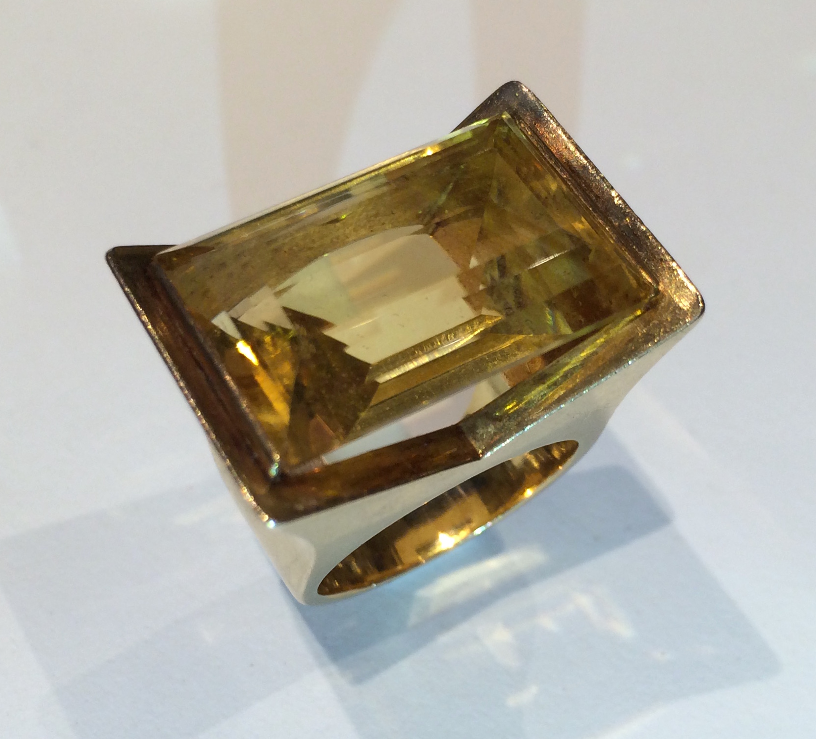 French “Retro” ring, a large emerald cut citrine (approx. 20 carats TW) set in a geometric 18K gold mounting, signed, c. 1940