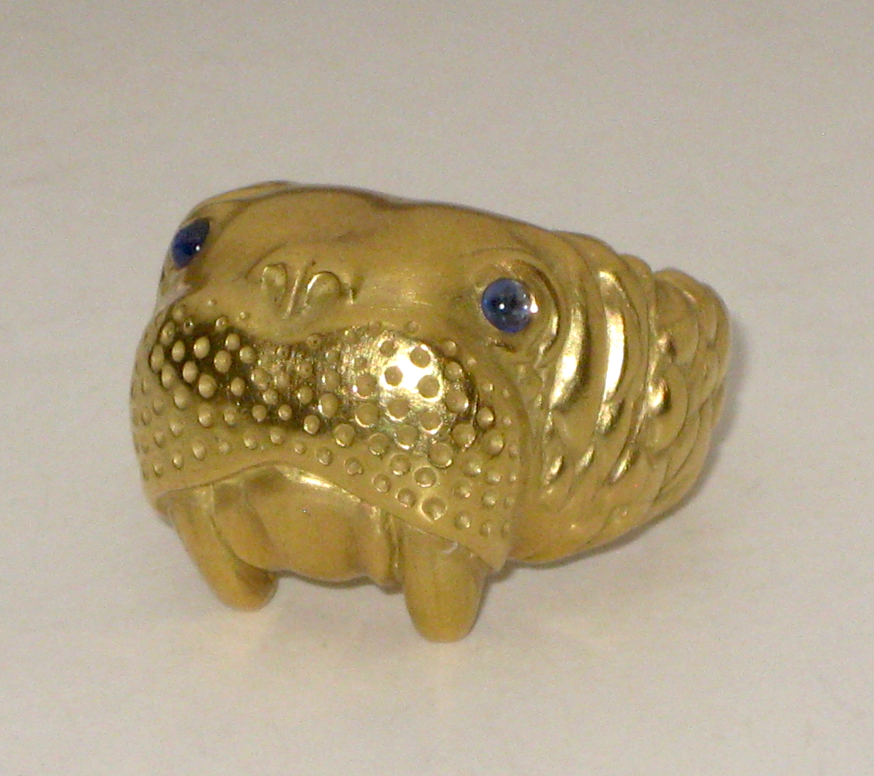 Angela Cummings “Walrus” ring, 18K gold set with cabochon sapphire eyes, signed, 1995