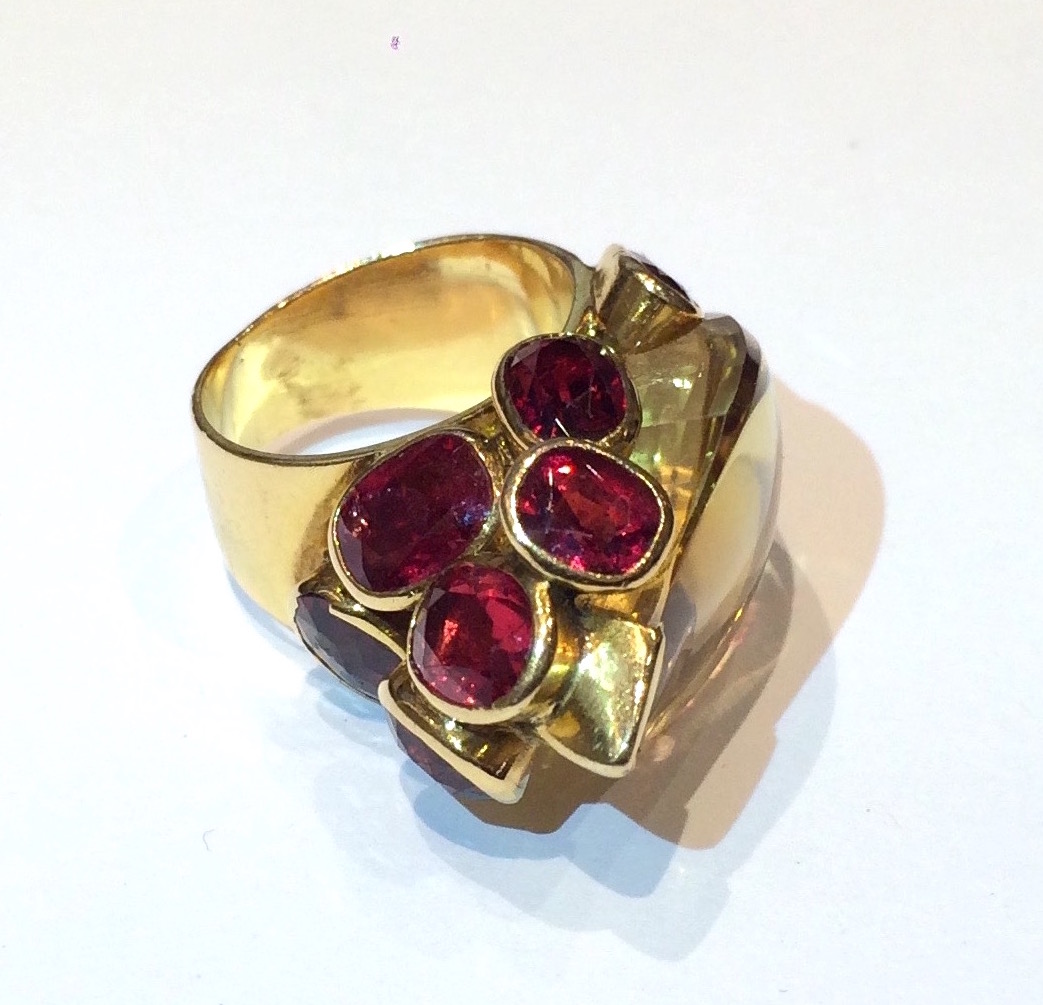 French Indian inspired gem cluster ring, 18K gold set with an exotic carved citrine and eight oval cut rubellites, signed, c. 1930’s