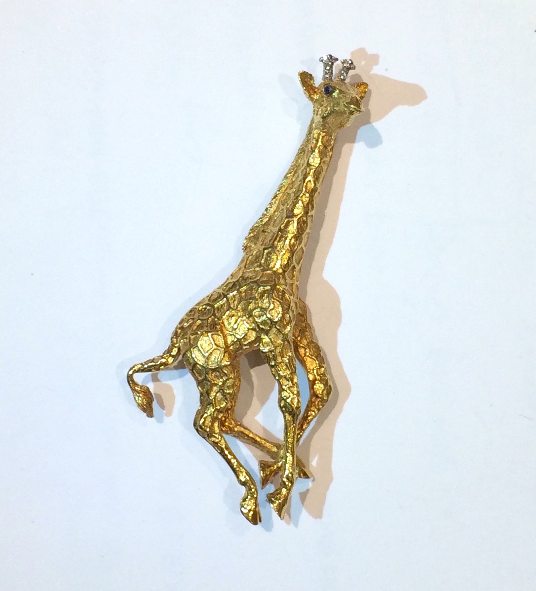 Tiffany & Co. 18K gold “Giraffe” brooch with sapphire eyes and diamond horns, signed, c. 1970’s