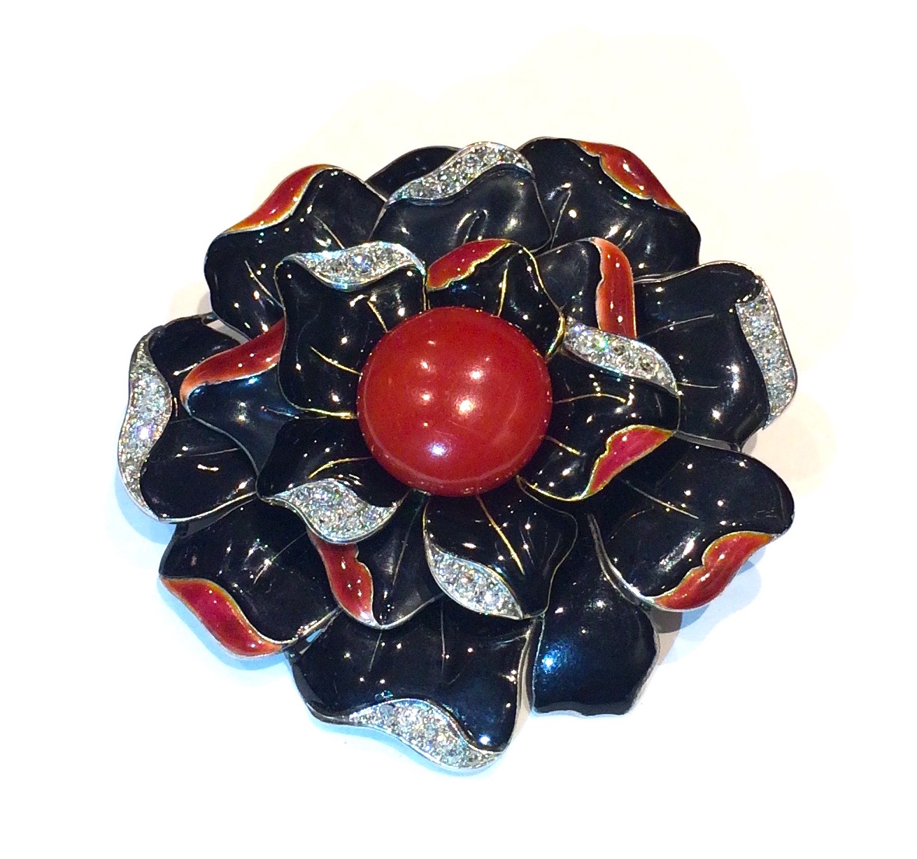 Madame Berlioz and Monsieur Leroy, Paris (Place Vendome, 19 Rue de la Paix active 1920’s through the 1940’s) “Camellia” brooch, black and coral enameled 18k gold further set with diamond pave furled leaf edges set in platinum with a  large red coral central cabochon, signed, c.1920’s
