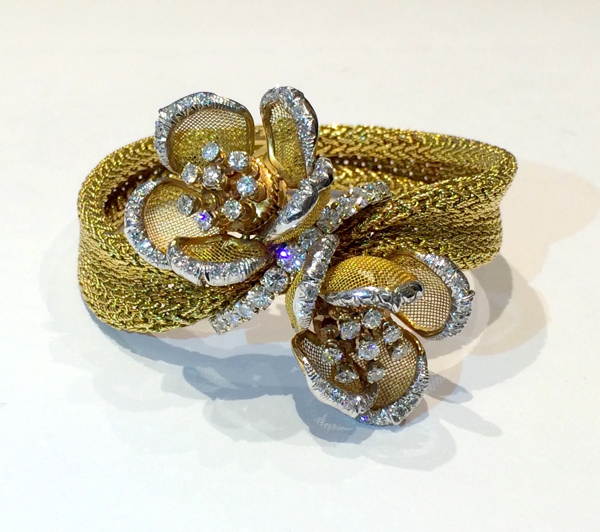 Piaget “Day and Night” flower bracelet with articulated petals and en tremblent stamens, 18K yellow gold and set with diamonds (approx. 4 carats), signed: J L in a diamond French maker’s mark, French Mercury mark for 18k and made for Export (3x), Made in France, c. 1950’s