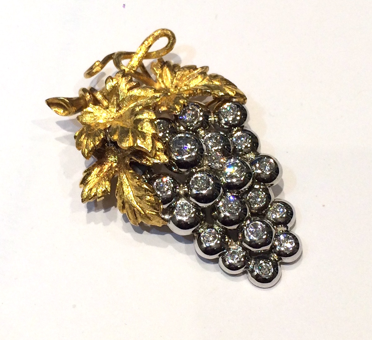 Stylized “Grape Cluster” brooch with platinum grapes set with 20 round cut diamonds (approx. 3.50 carats TW) and highly textured and detailed 18k gold leaves and vines, c.1980’s