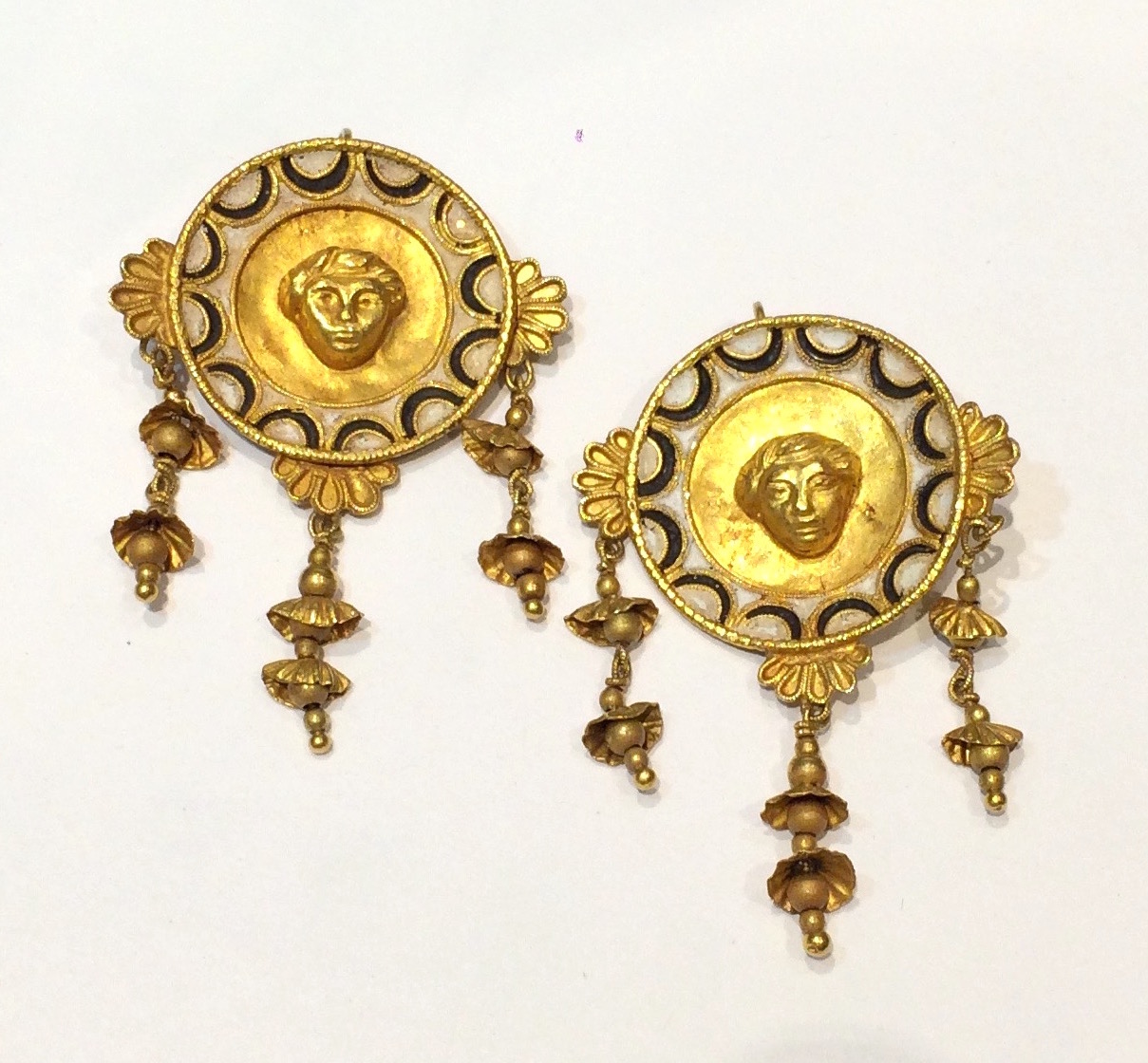 Giacinto Melillo (attr.) Italian Ancient Revival Medallion 18K gold pendant earrings with white and black enamel and central face motifs, hanging floral details, retailed in Paris, marked, c. 1880