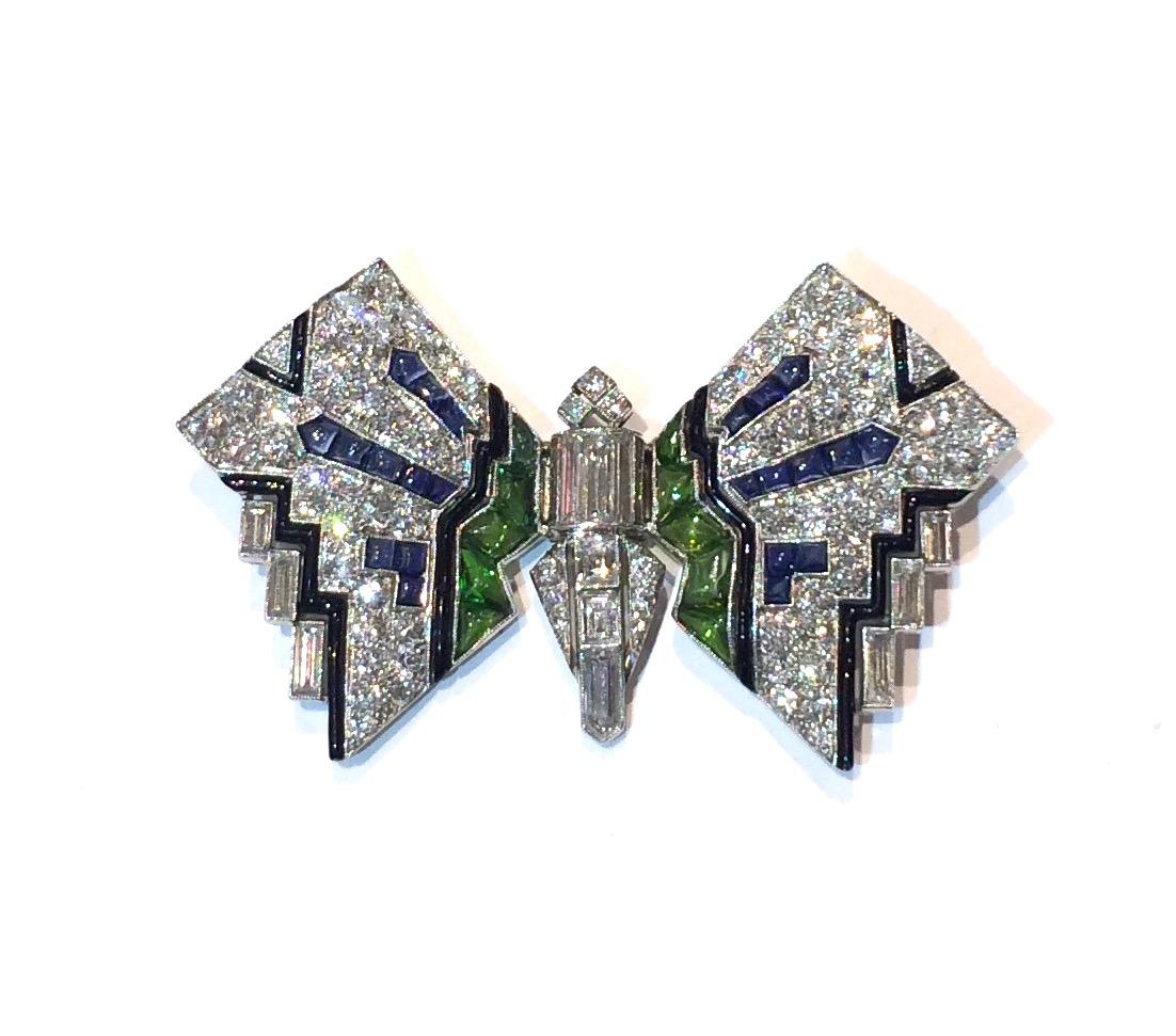Gustav Manz (designer) for Thomas Kirkpatrick & Co., Fifth Avenue, NYC Art Deco Butterfly brooch, 12 baguette diamonds and 83 round diamonds (approx. 11 carats TW), 22 contoured and buff cut sapphires and 10 contoured and buff cut peridot, black enamel details all set in platinum, signed, c. 1920’s
