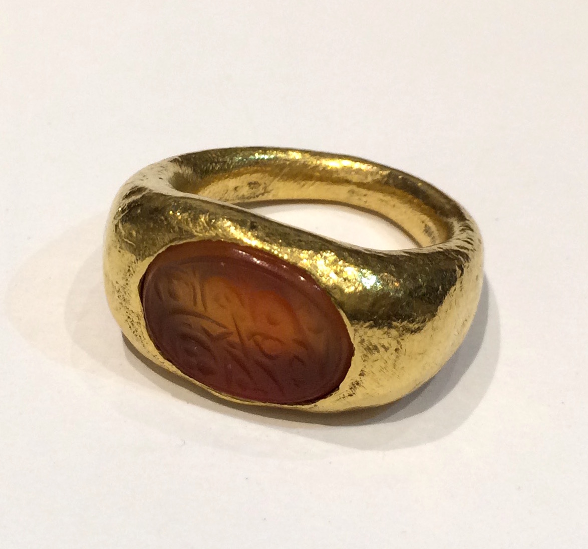 Ancient ring in 22K gold set with an oval carnelian intaglio with an inscription, “In the name of God the most gracious and merciful.”, c. 200 A. D.