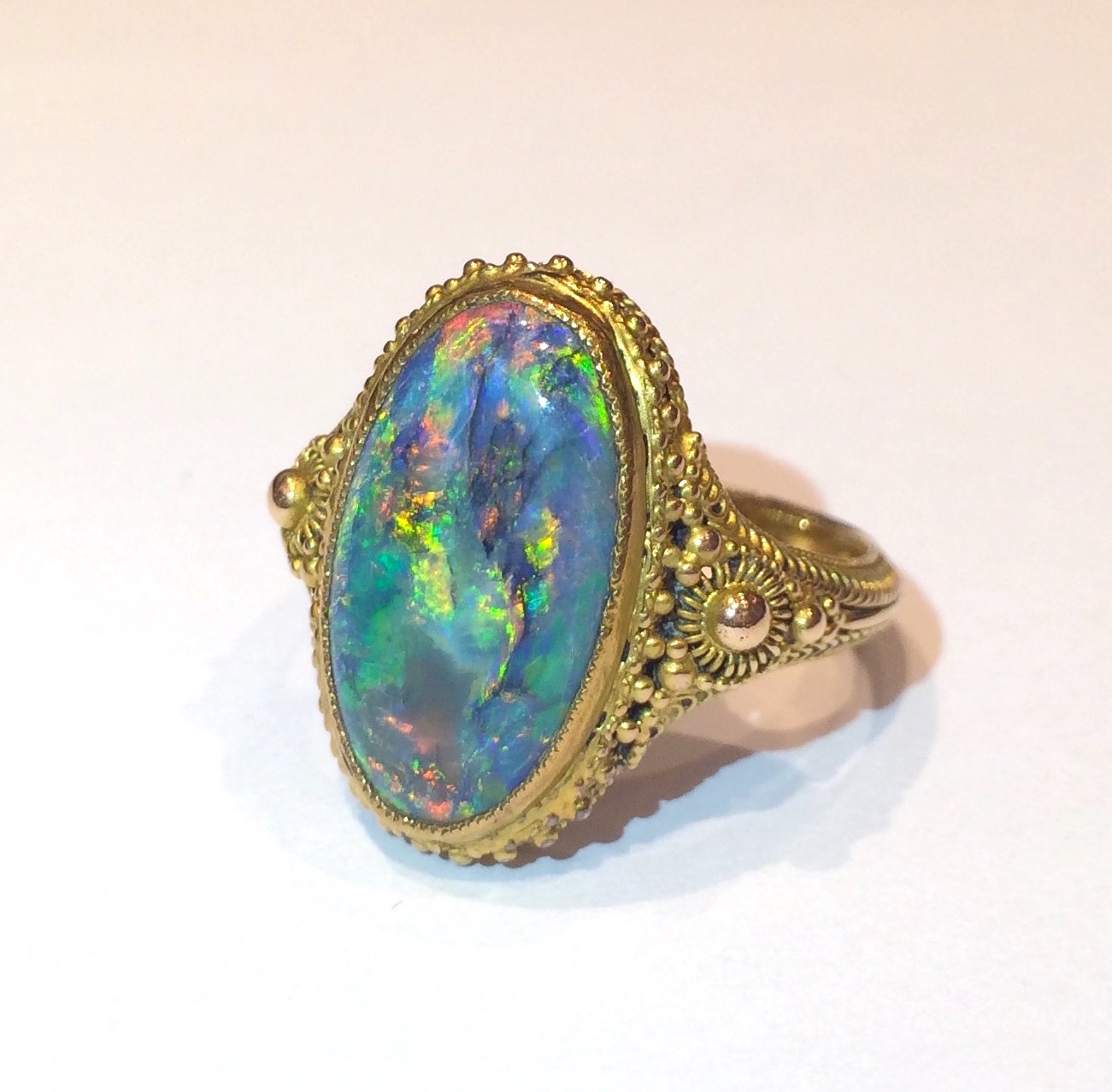 Marcus & Co. Arts & Crafts “Byzantine Revival” black opal (approx. 4 carats TW) ring in an elaborate wirework and applied beadwork 14k gold mounting, signed, c.1910