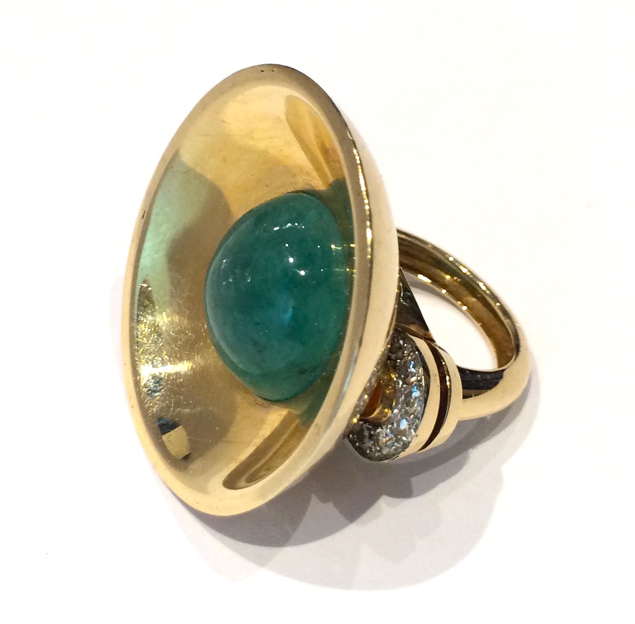 American Art Deco, cabochon emerald (approx. 14 carats TW) 18K rose gold ring with a large concave half dome surround and ring shank with two flanges on either side further set with 14 diamonds (approx. 1.50 carats TW), c. 1935
