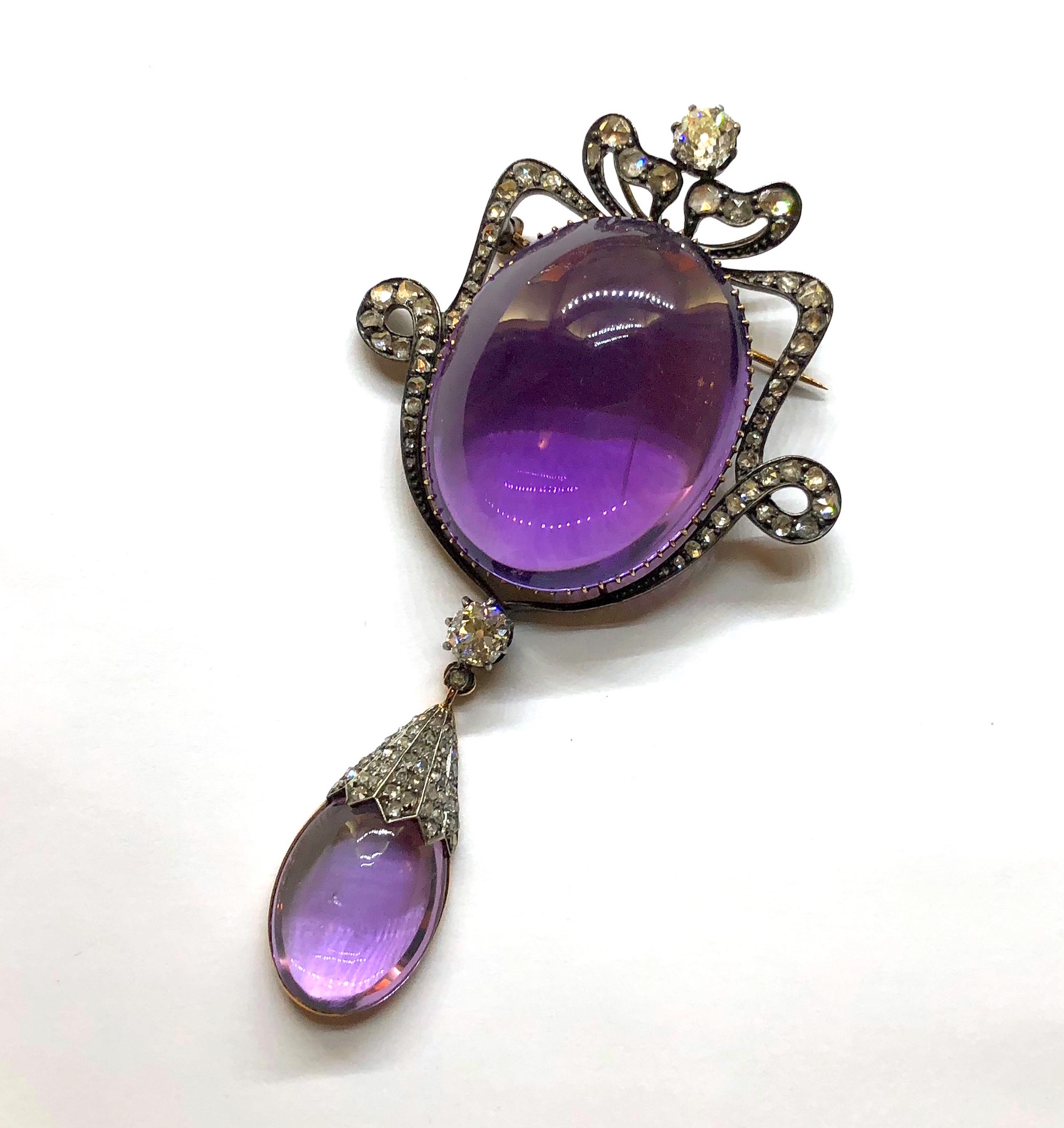 Belle Epoque large cabochon Amethyst pendant brooch (approx. 100+ carats TW) set with old mine cut diamonds and 2 fine old round cut diamonds (approx. 3 carats TW) all in a silver top gold mounting, c. 1895