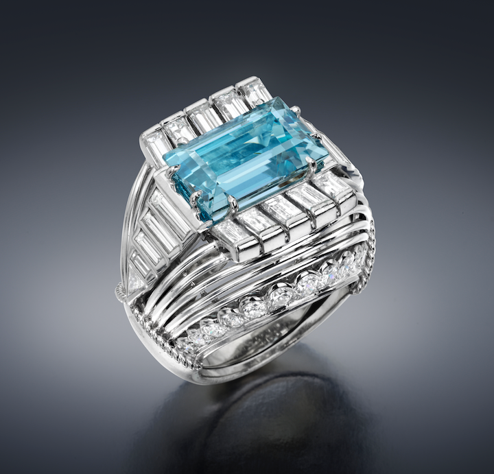 Cartier (attr.) “Bombe” cocktail ring set with a emerald-cut aquamarine (approx. 6 carats TW) 26 round-cut diamonds, 18 baguette diamonds and two triangle-cut diamonds (approx. 6.5 carats TW) all in an elaborate platinum mounting with open platinum wire details, Marked: French “Mask” platinum guarantee mark for remarking old production pieces, c.1950