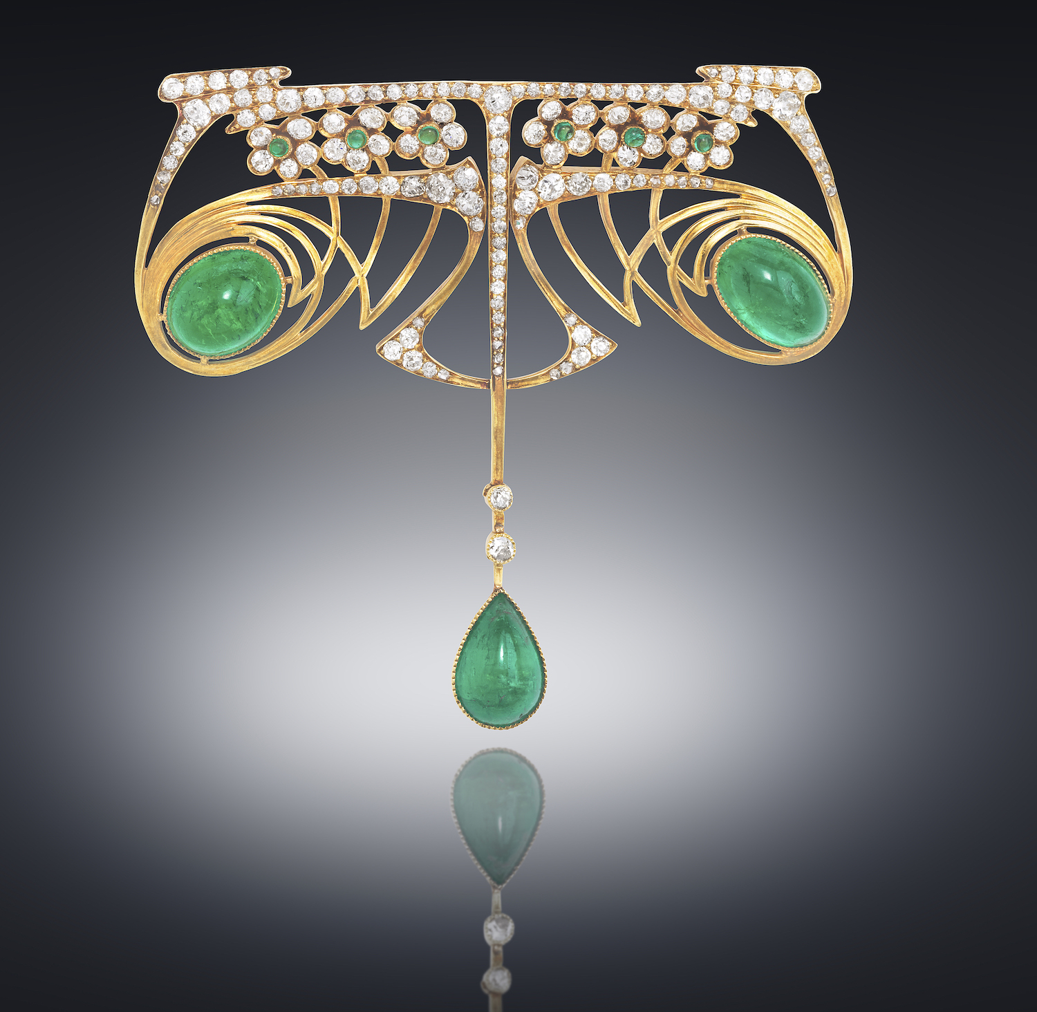 Theodore B. Starr (attr.) American Art Nouveau brooch, High style openwork graphic design in 18k gold and set with two large oval cabochon emeralds and one tear drop emerald (20 carats TW) with 144 old European round cut diamonds (approx. 9 carats TW) and six small cabochon emeralds as accents, c. 1900