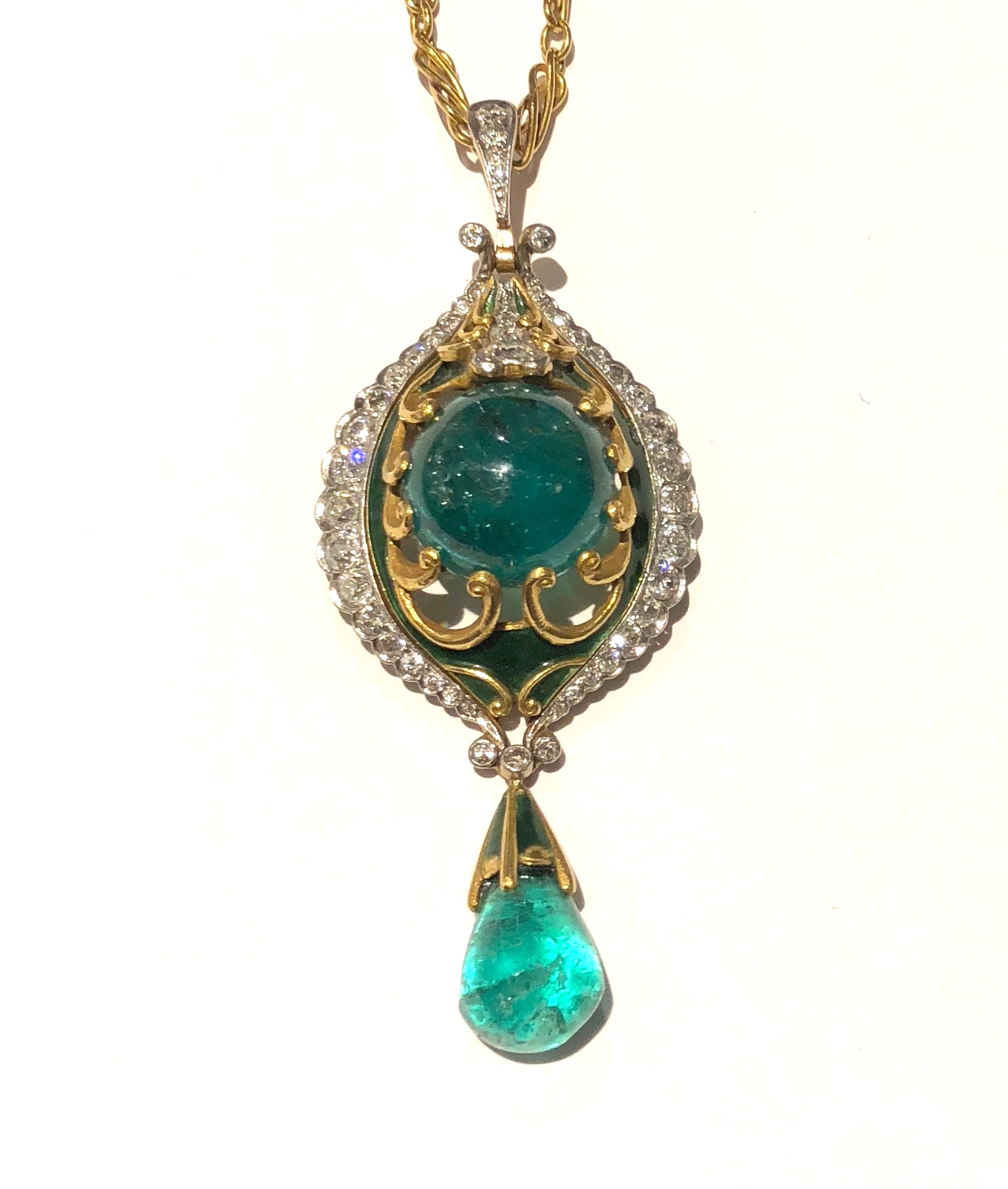 Marcus & Co Art Nouveau pendant necklace, Handwrought 18K yellow gold set with a large cabochon natural emerald center stone surrounded by green enamel details with gold looping bezel mounts and platinum topped diamond side details set with 43 diamonds, cabochon emerald pendant drop with a green enamel and gold capped top, signed, c. 1900
