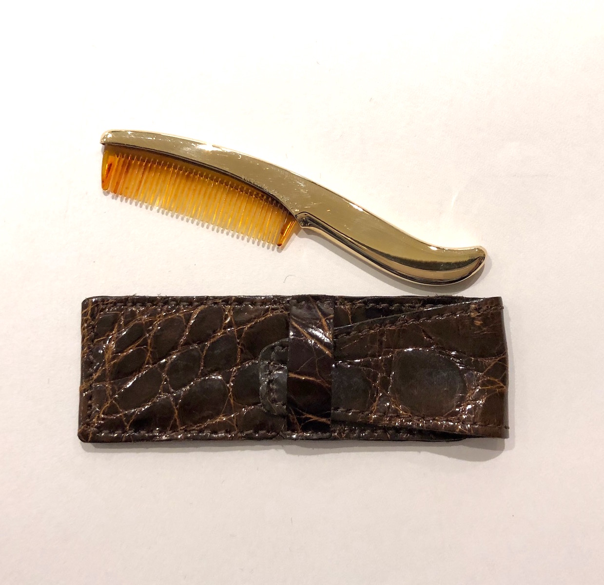 Tiffany & Co Art Deco “Mustache” comb, 14K gold in a contoured form with the original tortoise shell comb and brown alligator slip case, signed: Tiffany & Co. 14K, square bowtie mark (possible maker’s mark), c. 1930’s