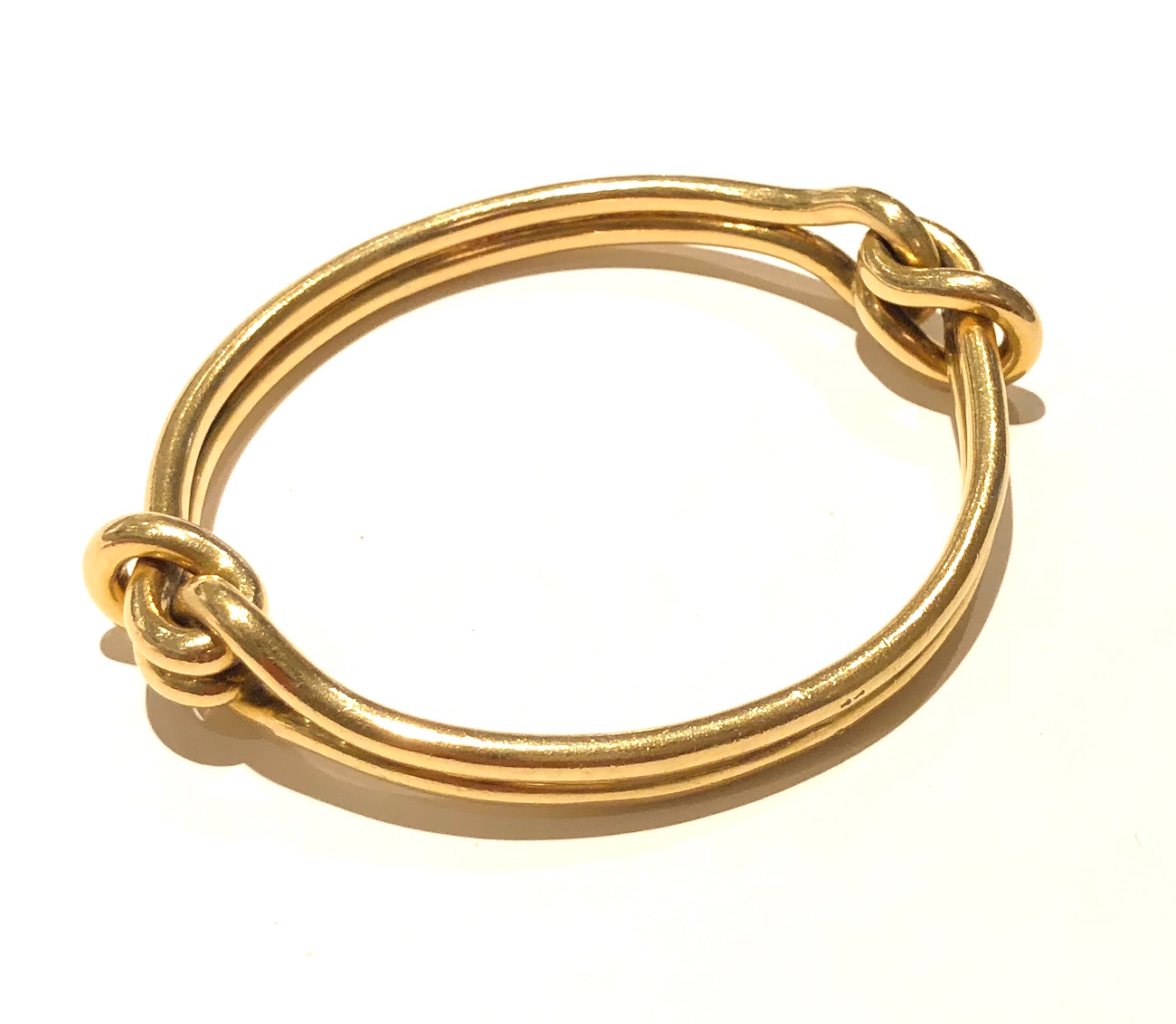 Cartier Paris 18K gold “Knot” bangle bracelet, signed: Cartier (script signature) Cartier touch mark, French Eagle’s head touch mark for 18K gold (2x), c. 1960’s