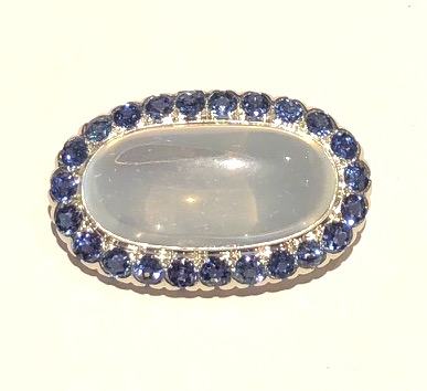 Louis Comfort Tiffany for Tiffany & Co. “Oval Moon” brooch set with a large gem quality moonstone (approx. 43 carats) set with 23 Montana sapphires (approx. 8 carats TW), marked: 10% Irid. Plat, c. 1920