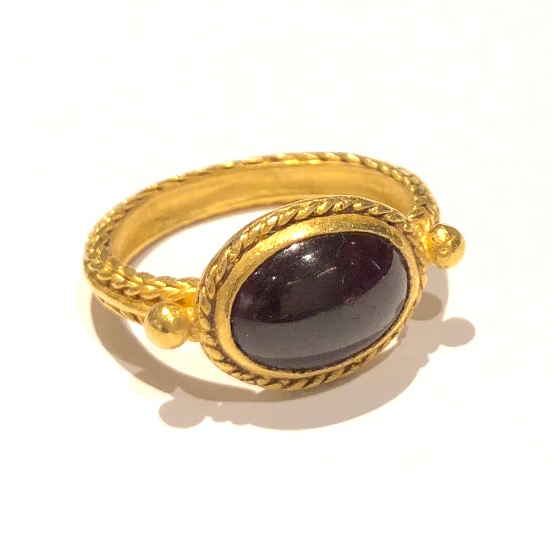 Roman, 3rd Century AD detailed high karat gold (22k-24k) ring set with a gem quality cabochon red garnet (approx. 6 carats)