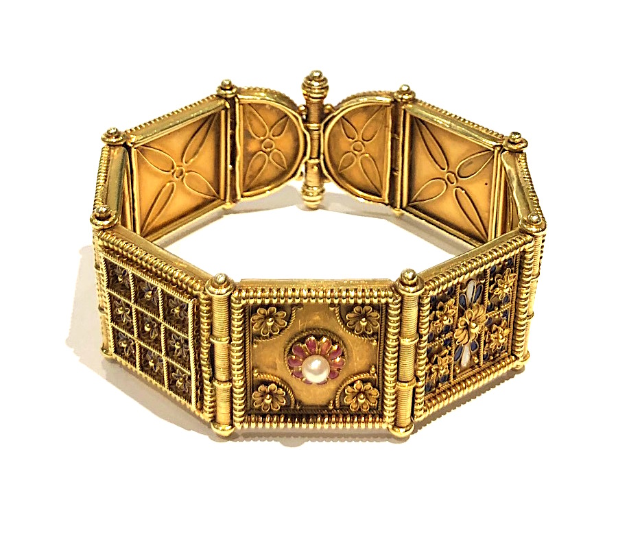 Giacinto Melillo (1846-1915) Naples “Etruscan / Archaeological Revival” Campana bracelet in 18k gold with extremely delicate and elaborate granulation gold work, delicate applied gold wire-work and gold beading further accented with polychrome enamel details, two cabochon bead emeralds and a pearl on 7 hinged square panels and two semi-circular panels, signed: G. Melillo touch mark on top of the end screw clasp and Triunfo (triumph) in a cartouche on the back of one of the arcing panels, c.1870