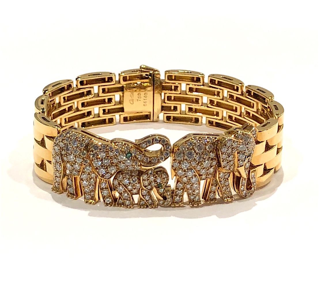 Cartier, Paris “Elephant” Maillon Panthere bracelet in 18k gold and set with 200 round cut diamonds (approx. 10 carats TW) and three round cut emeralds for the eyes, signed: Cartier (script signature), no. 641403, 750, French Eagle’s head assay mark for 18k gold (3x), maker’s mark in a diamond cartouche, c.1980’s