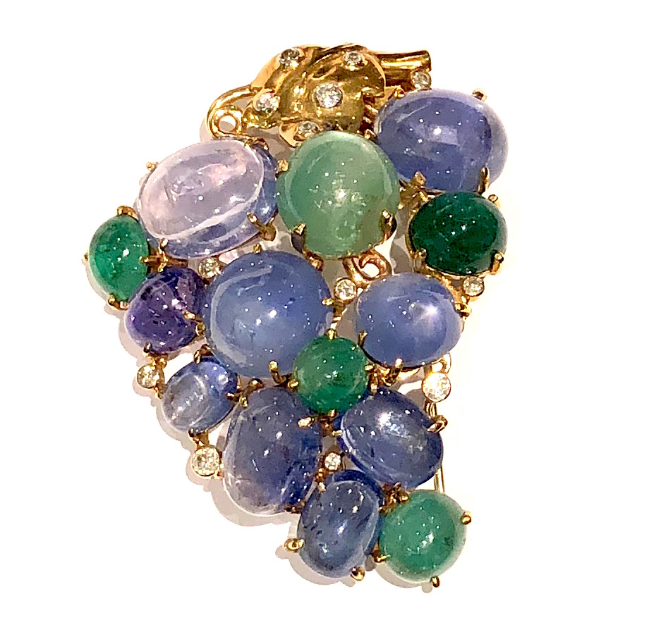 Seaman Schepps “Grape” cluster clip/brooch set with 9 large cabochon sapphires (approx. 85+ carats TW), 5 large cabochon emeralds (approx. 35+ carats TW) and 13 round diamonds (approx. 2 carats TW) set in a 14K yellow mounting with leaves and vines, signed Seaman Schepps and 14k, Dimensions: 2 3/4 inches long x 2 1/4 inches wide, c. 1940