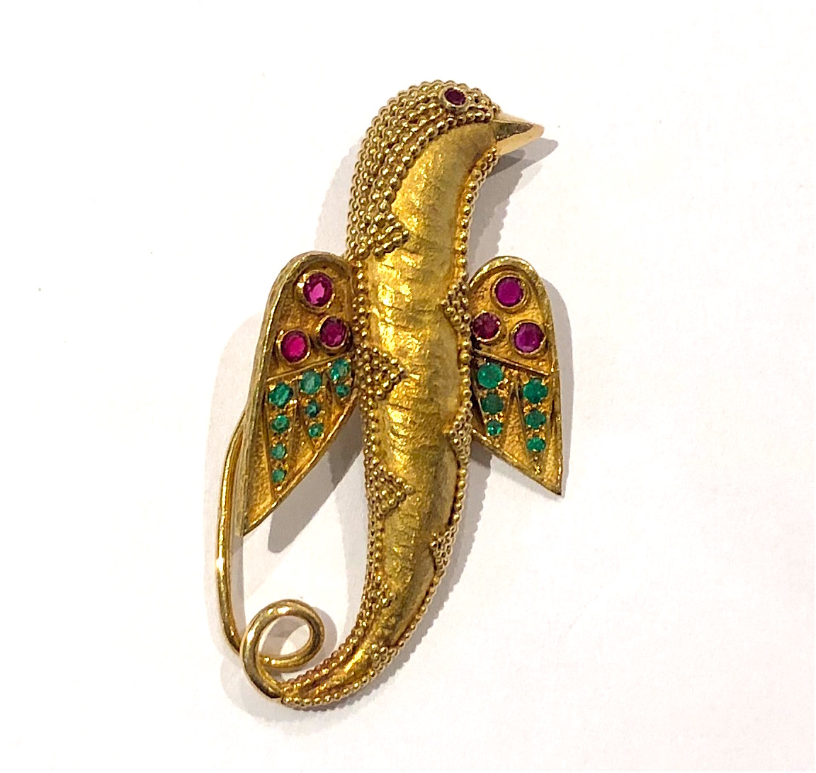 Van Cleef & Arpels, Paris, “Etruscan Revival” theme bird brooch in 18k gold set with 7 rubies (approx. 0.80 carats TW) and 15 emeralds (approx. 0.40 carats TW), signed: VCA, France, C in a circle (copyright mark), no.  1K84.1, French Eagle’s head mark for 18k gold, c. 1940’s
