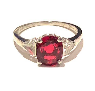 Raymond Yard (Founded 1922), gem quality spinel and diamond ring set with an oval spinel (approx.  2 carats TW dimensions: 9mm x 8mm x 4mm) and two fancy cut pentagon shaped diamonds set on either side (approx. 1 carat TW), signed: YARD, R.F.C. to three initials ending in J (rubbed), Dec. 17, 1950 (all in script), 1950