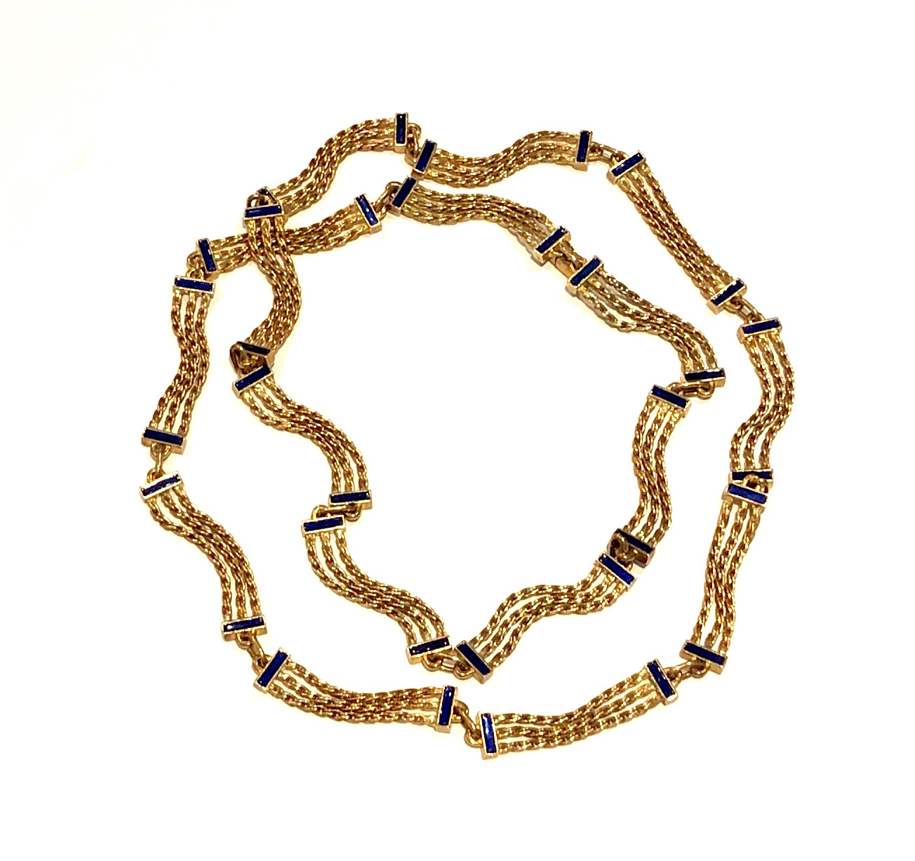Cartier London, long and partitioned 18k gold link chain with cobalt blue enamel panel details, signed: Cartier, London (script signature), 750 in a diamond for 18K gold, French maker’s touchmark, no.P4450, Length: 36½ inches, c.1950’s