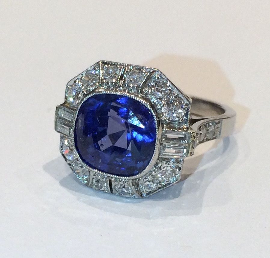 Art Deco cushion shape natural Burmese sapphire ring (approx. 7 carats TW, G.I.A. certificate, no heat) set in an intricate platinum mount with 4 baguette diamonds and 16 round diamonds (approx. 4 carats), c. 1930