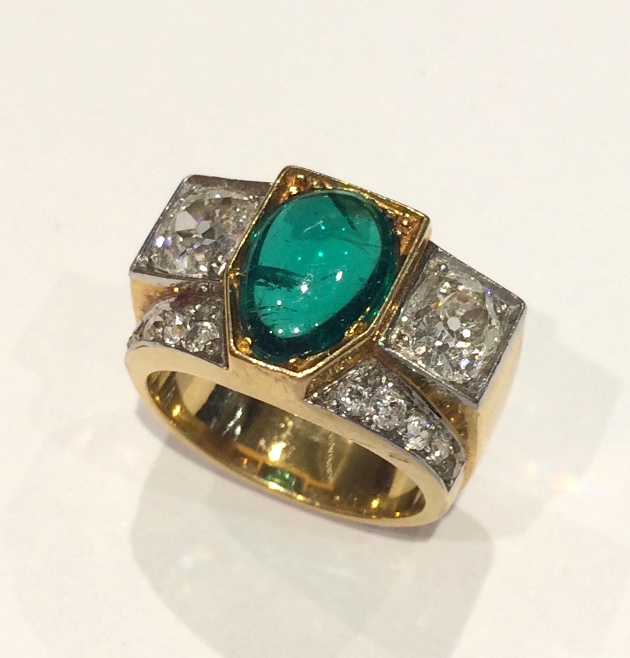 French Art Deco Emerald ring set with a very fine cabochon emerald (approx. 3 carats TW) and two old European cushion cut diamonds (3 carats TW) and further set with 12 round cut diamonds all set in 18K gold, signed, c.1920’s