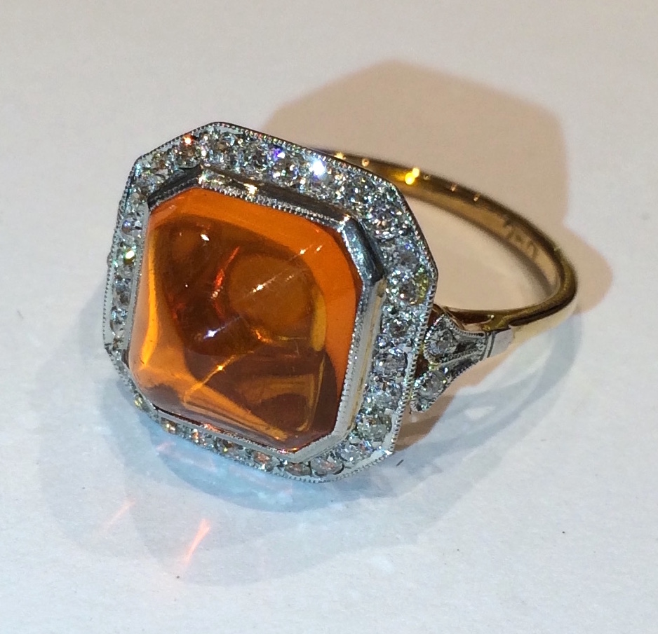 Edwardian Sugarloaf Fire Opal (approx. 4 carats TW) ring with 32 diamonds set in a milligrain platinum topped 18K yellow gold mounting, marked, c. 1910