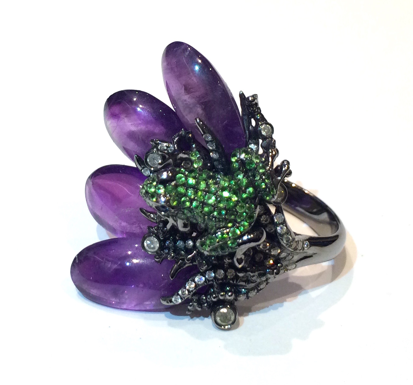 Asian Art Nouveau inspired “Frog on a Lily Pad” ring, 18K white gold with a gunmetal surface, cabochon amethyst petals, a three dimensional frogs pave set with tsavorites and sapphire eyes, diamond details, marked, c. 2005