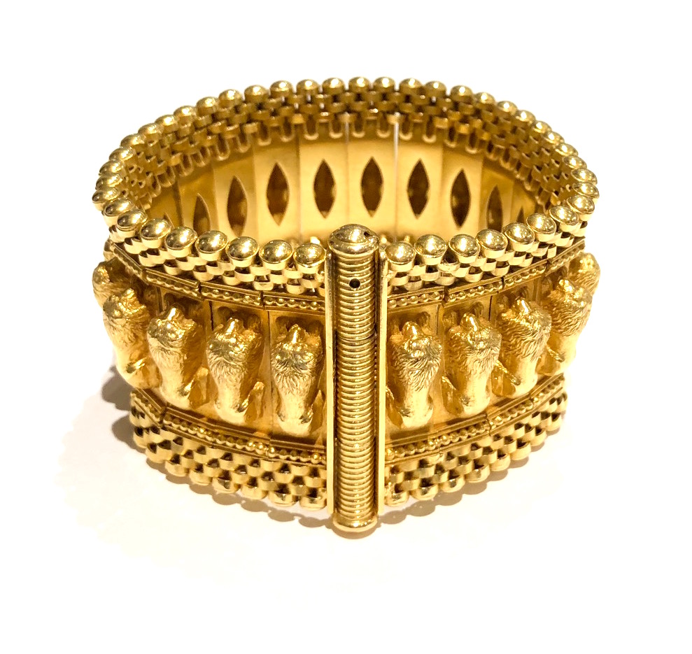 Bulgari, Rome, Revivalist “Lion Recumbent” wide bracelet, 18k gold with an elaborate woven edge detail and further decorated with 22 full figure resting lions, signed: BVLGARI, Made in Italy, 18k, original brown leather envelope, c.1940’s